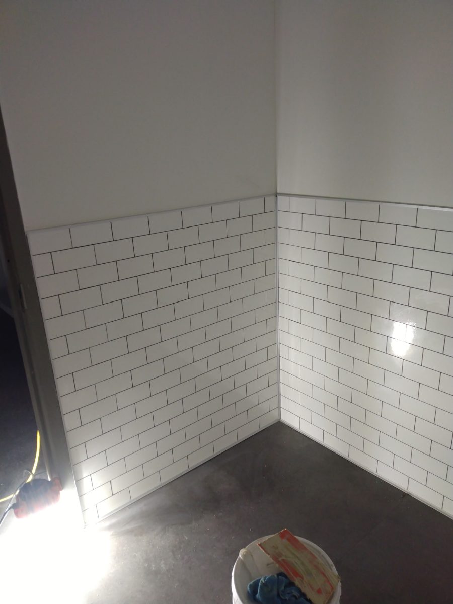 White subway tile wainscot installation in a bathroom, Tucson area