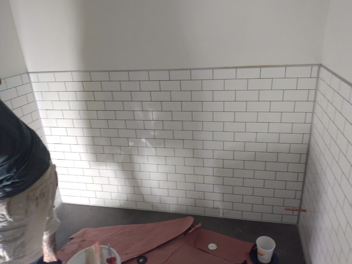 Subway-tiled restroom walls with dark grout, Tucson area